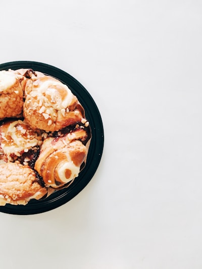 Assorted sweet pastries arranged neatly on a simple white plate with soft natural lighting