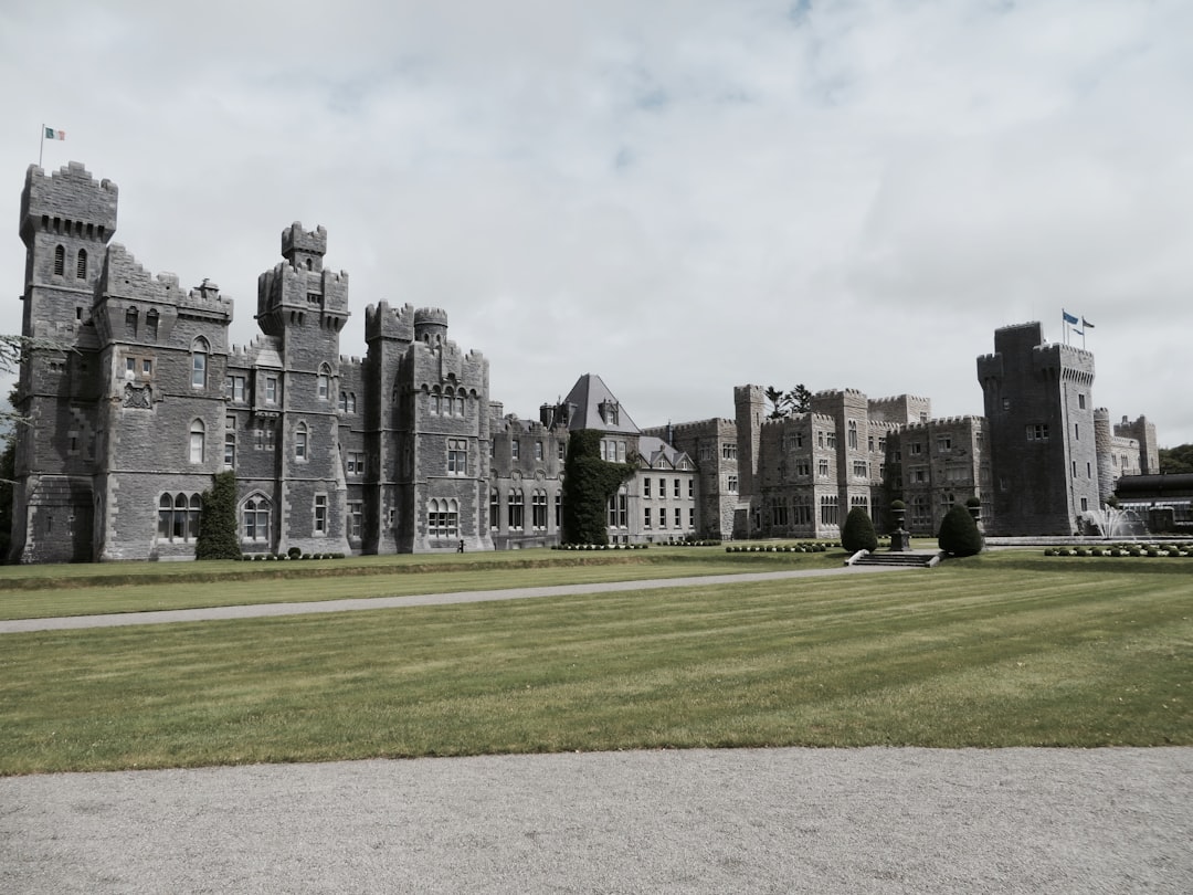 landscape photo of gray concrete mansion under blue sky, Regal Architecture