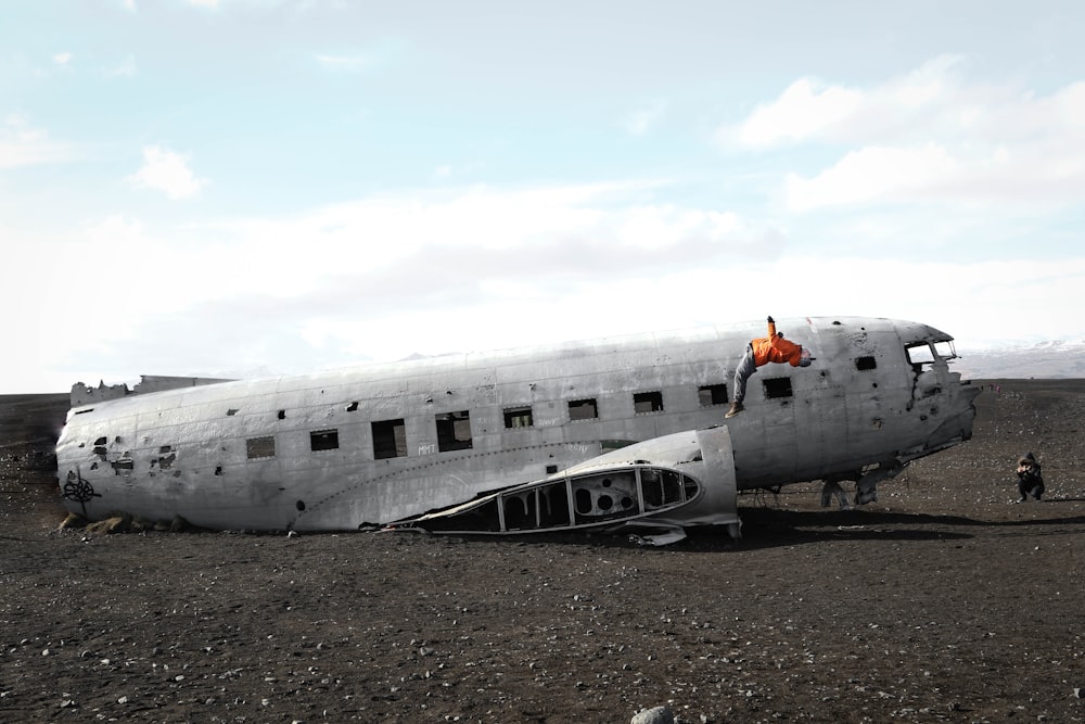 person doing back flip on wrecked plane