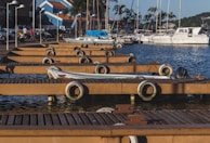Speedboat docking at a wooden jetty with palm trees swaying in the background.