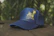 Close-up of a stylish cap with a unique design resting on a wooden table.