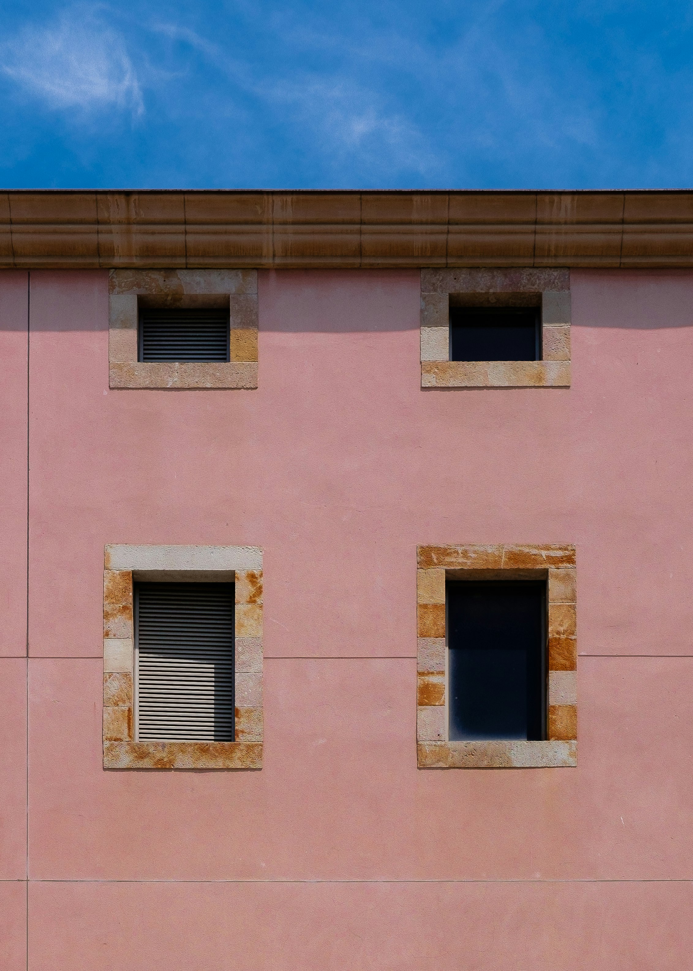 minimalist photography of concrete building with four windows