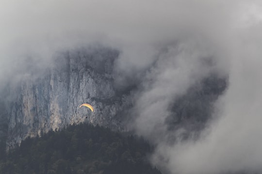 selective color of air gliding near fog in Annecy France