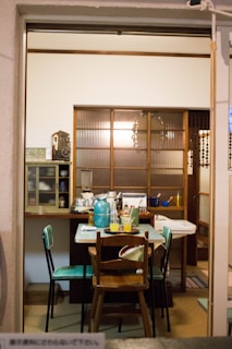 A cozy dining nook featuring a rolling cart doubling as both storage and a serving station with elegant dishware.