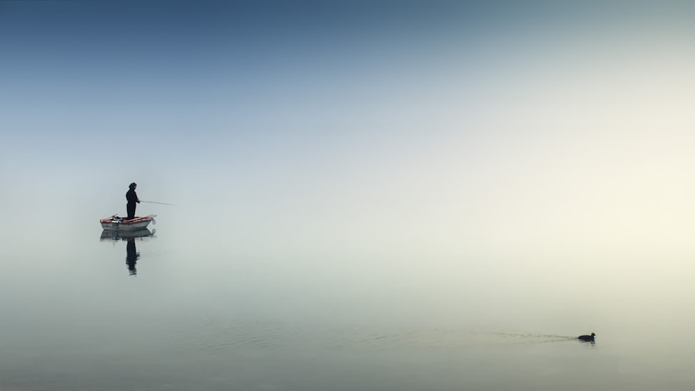 rule of thirds photography of man on boat