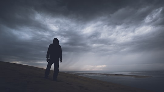 silhouette photography of person under gray clouds in Dune du Pilat France