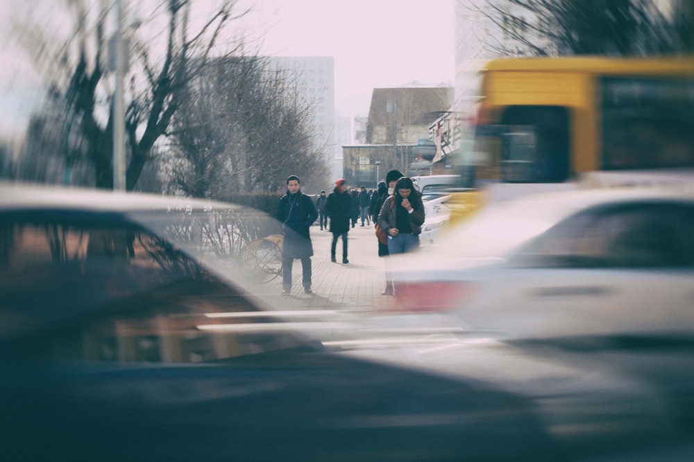 people walking on sidewalk during daytime