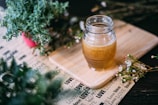 shallow focus photography clear glass jar on chopping board