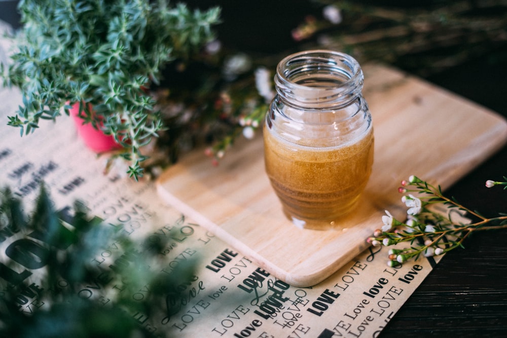 shallow focus photography clear glass jar on chopping board