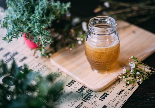 shallow focus photography clear glass jar on chopping board