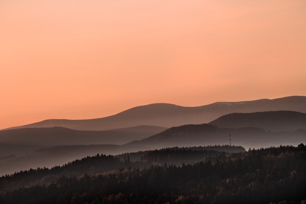 silhouette of mountain during orange sky