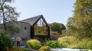 A happy family standing in front of their new modern home in Antalya