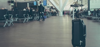 unattended black luggage inside airport