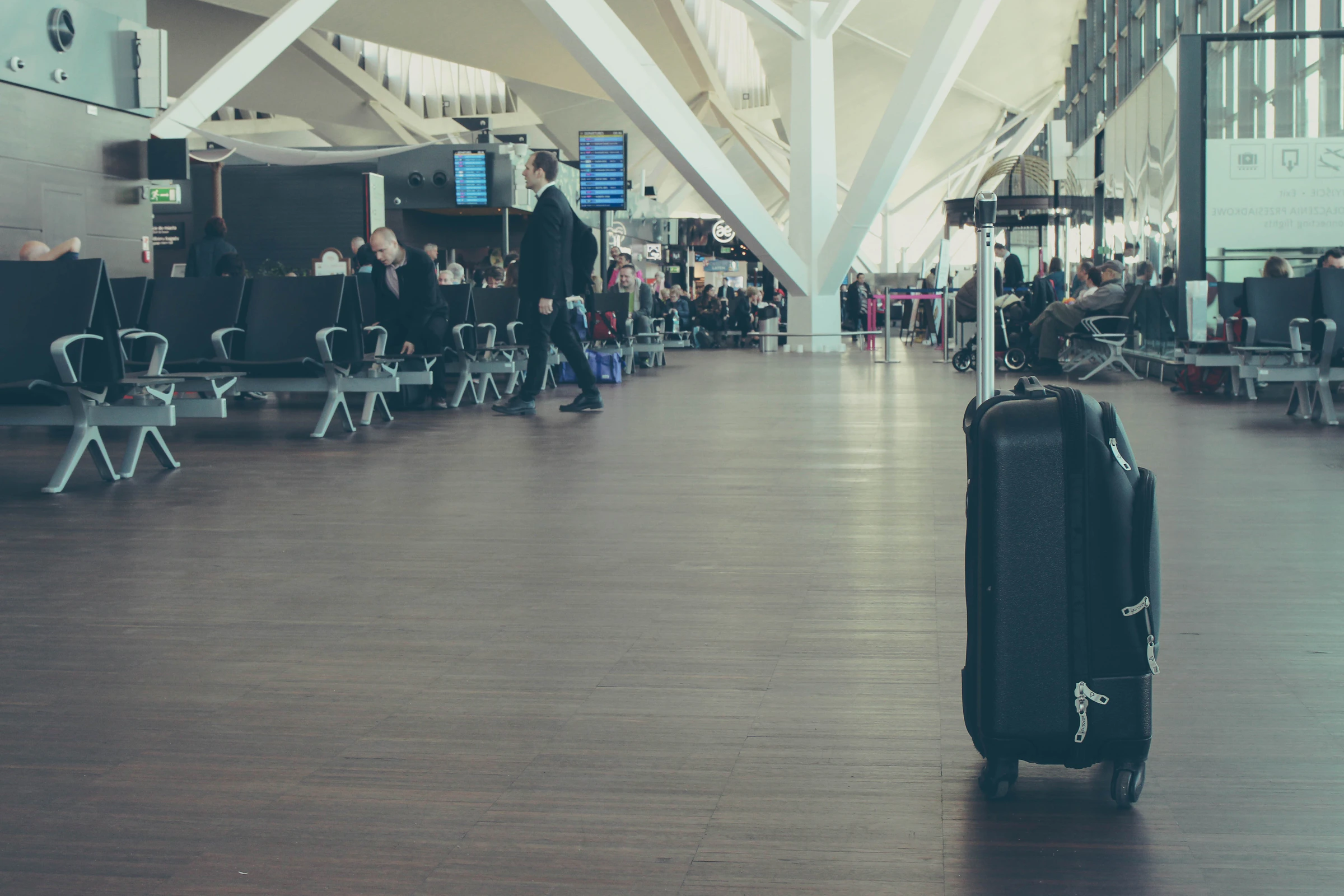 Suitcase waiting inside an airport terminal before departure