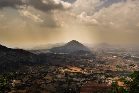 grass covered mountains near city during daytime in Bengaluru India