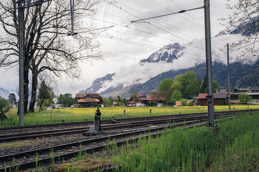 a train track with a mountain in the background