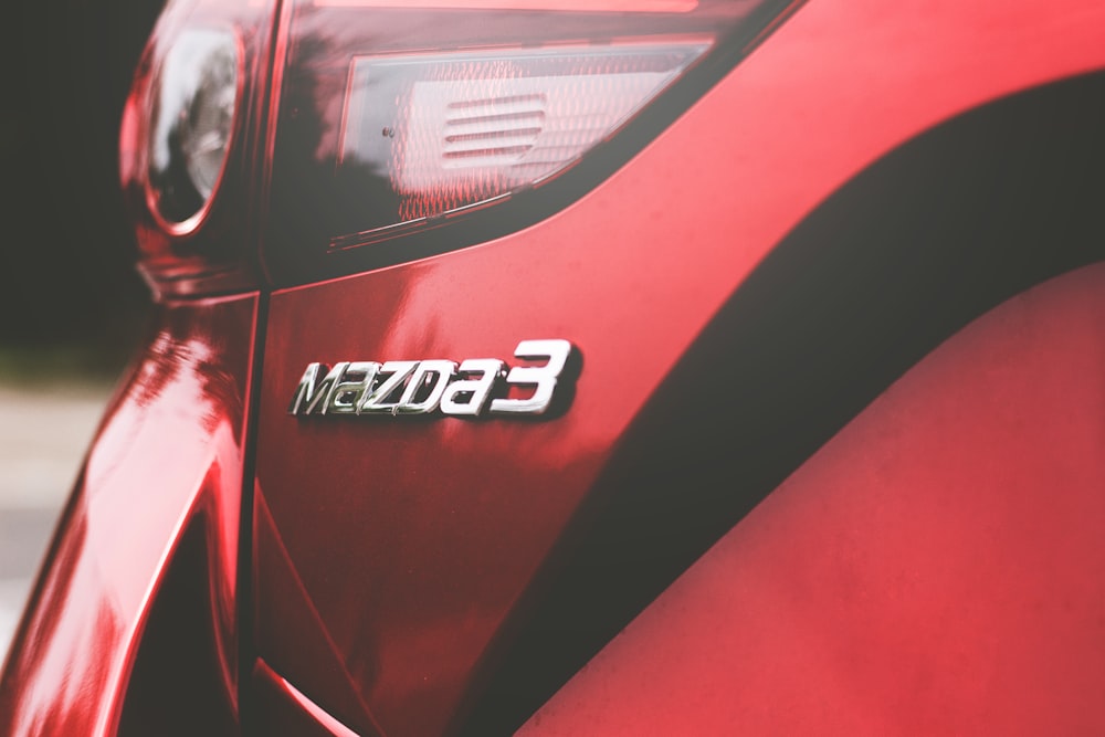 closeup photography of red Mazda 3 vehicle
