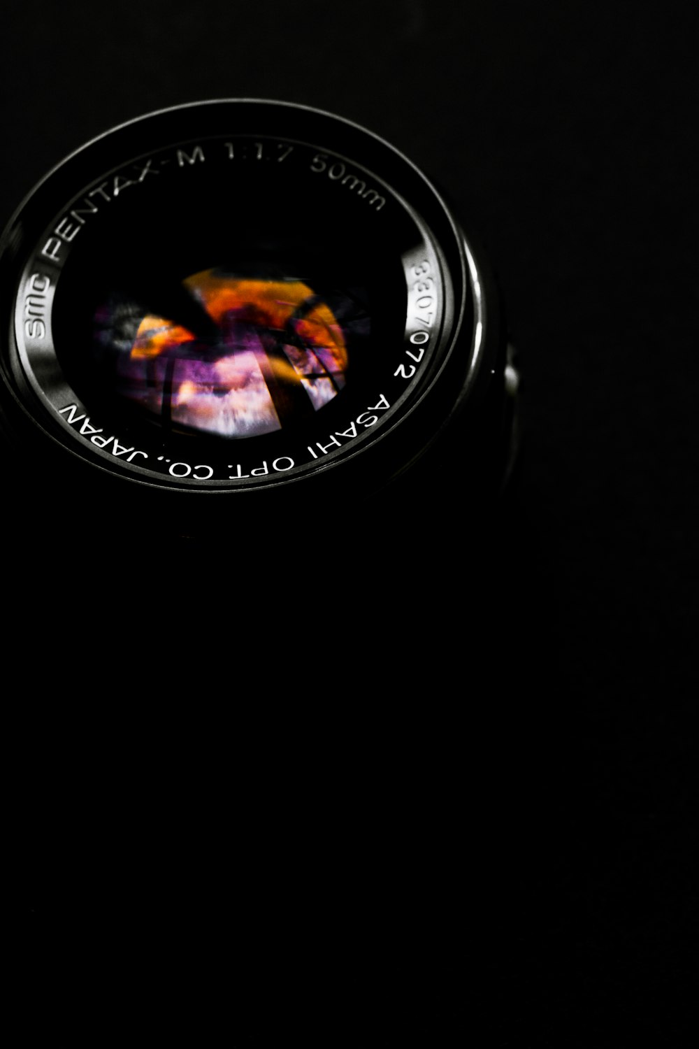 black telephoto lens on black surface
