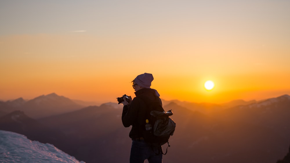 man holding DSLR camera