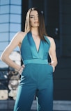 woman wearing jumpsuit standing on floor