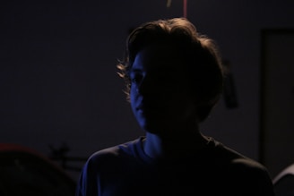 Artistic shot of a model silhouetted against soft, diffused lighting.