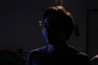 Artistic silhouette of a model framed by soft natural light, emphasizing form and texture.