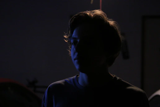 A shadowy silhouette of a woman bathed in soft golden light, evoking mystery and allure.