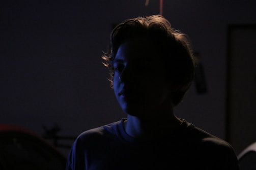 Artistic shot of a model silhouetted against soft, diffused lighting.