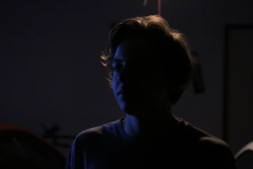 Artistic silhouette of a model framed by soft natural light, emphasizing form and texture.