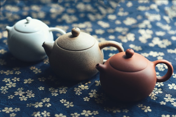 Three Yixing teapots neatly arranged in a row
