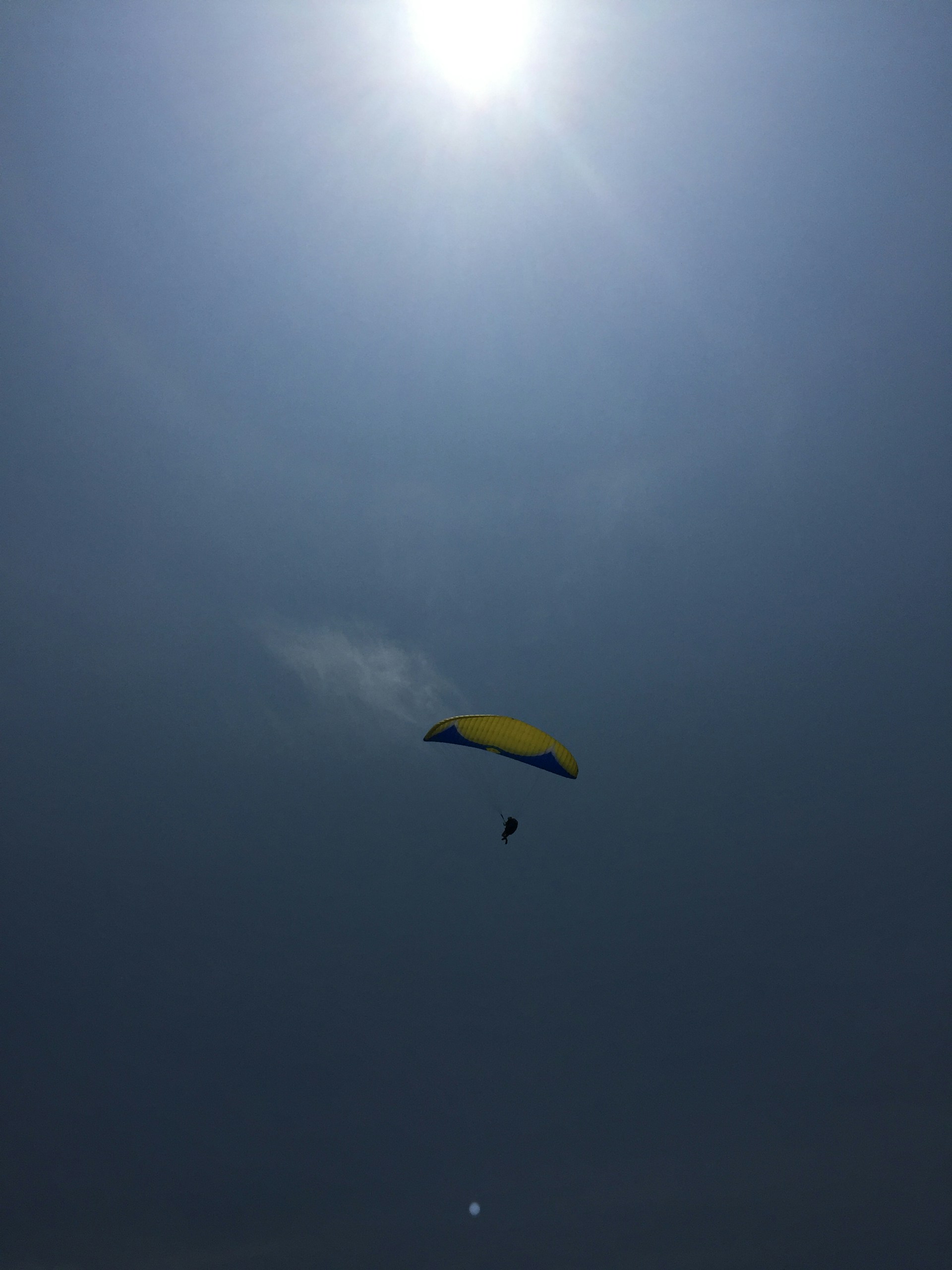 woman wearing yellow long-sleeved dress under white clouds and blue sky during daytime
