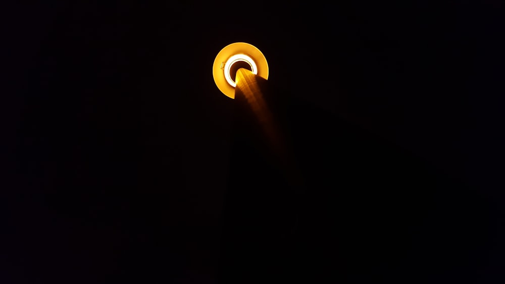 a close up of a street light in the dark