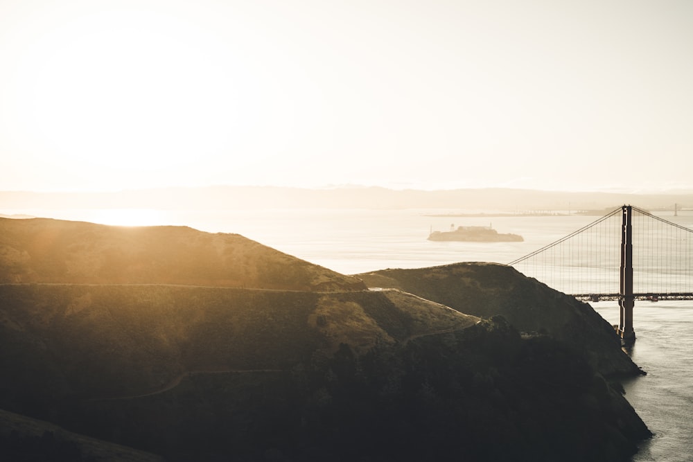 bridge near mountain at golden hour