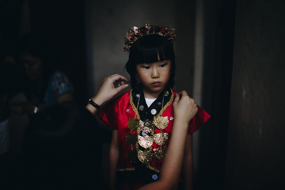 woman fixing girl's dress