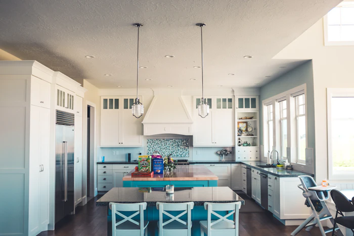 A white kitchen with a range hood and an island