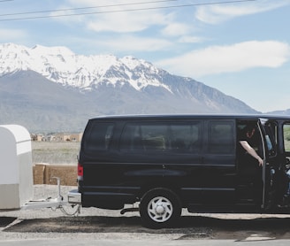 parked and opened door black van with white trailer