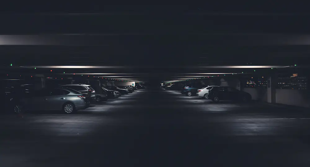 Rows of cars parked in a multi-level parking garage