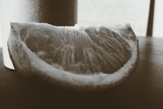 A close-up of a hand-drawn orange slice with delicate watercolor textures, reflecting artisanal craftsmanship.