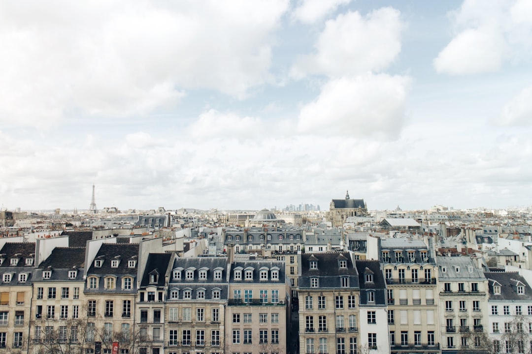 aerial photography of city building s, Paris buildings with clouds