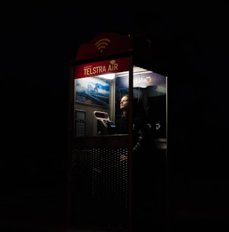 man inside telephone booth