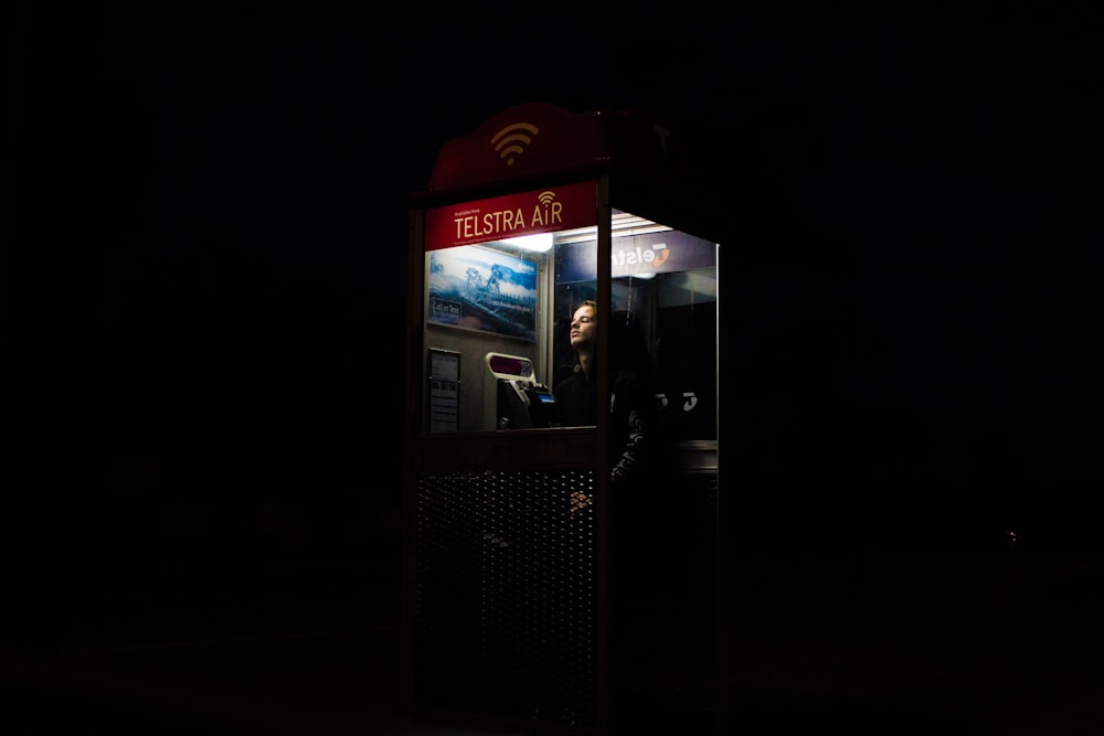 man inside telephone booth