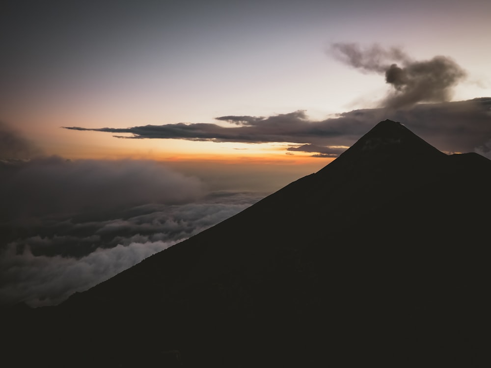 silhouette of mountain with clouds