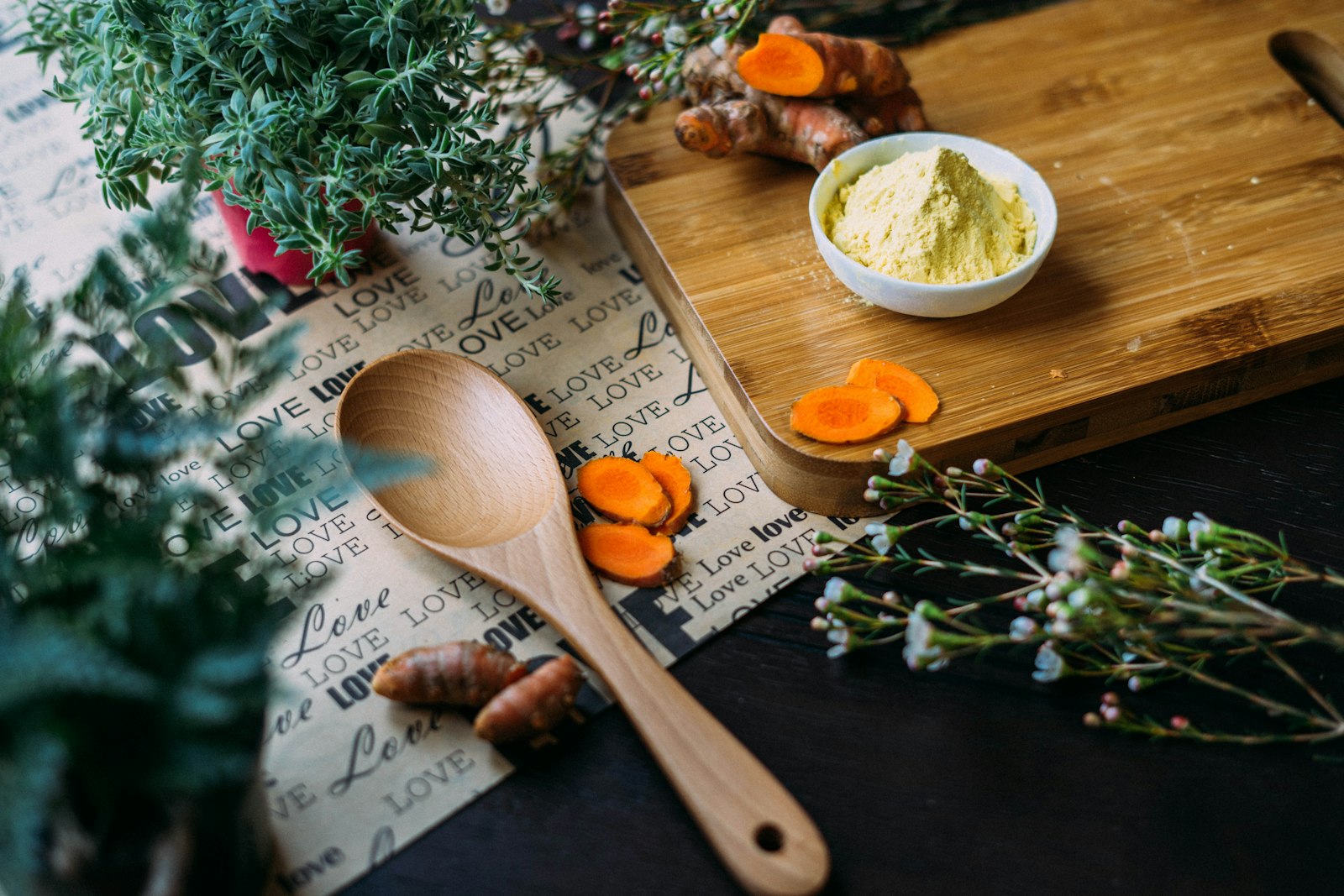 Fresh produce including leafy greens, tomatoes, peppers, and citrus arranged on a rustic wooden surface