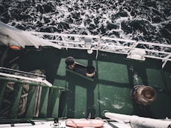 Close-up of a surveyor inspecting a ship's deck with specialized equipment