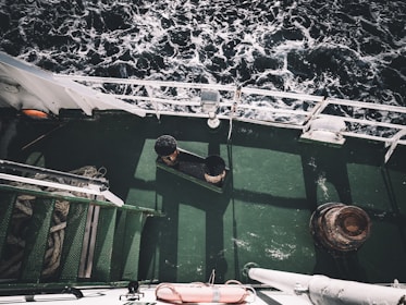 Close-up of powerful degreaser being sprayed on a ship deck.