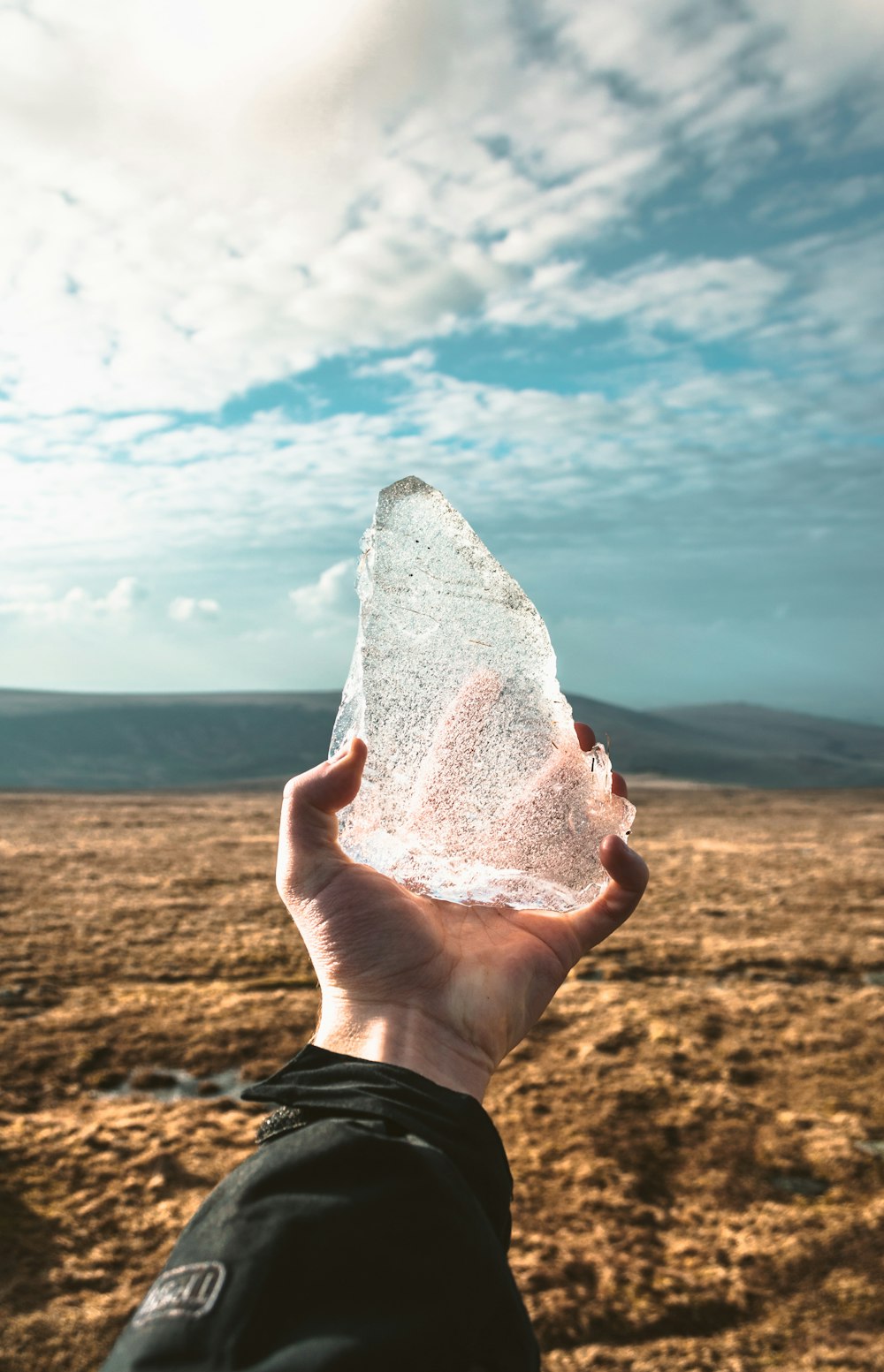 person holding ice during day time
