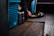 Close-up of colorful Punjabi sandals resting on a rustic wooden floor with soft natural light.