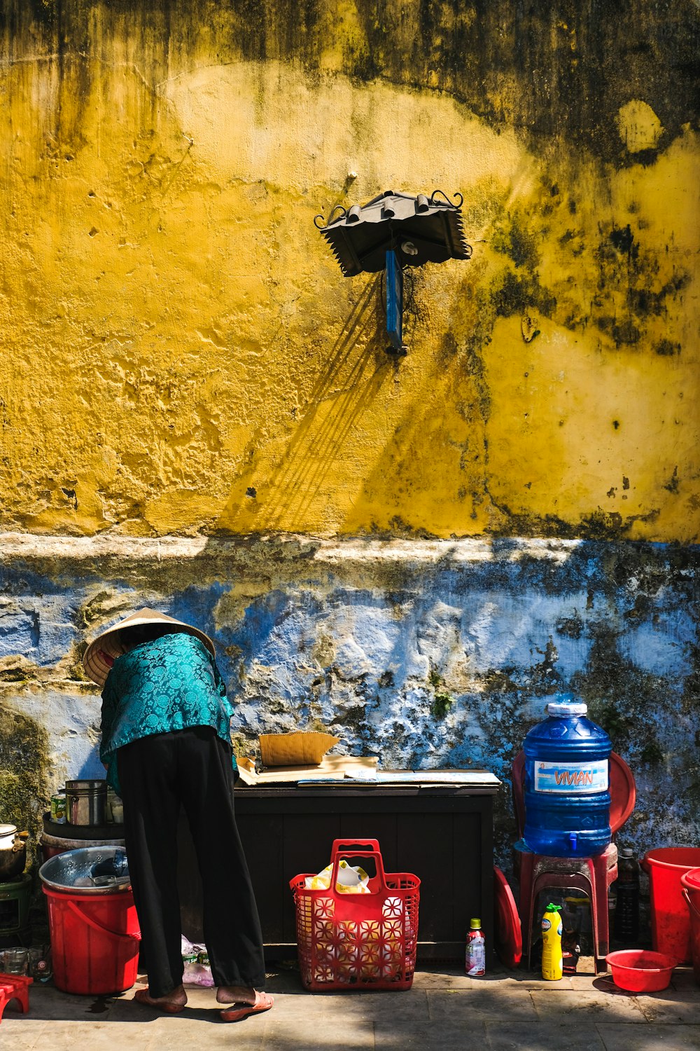 photo of person wearing hat facing wall