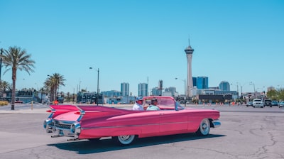 people riding pink car retro zoom background