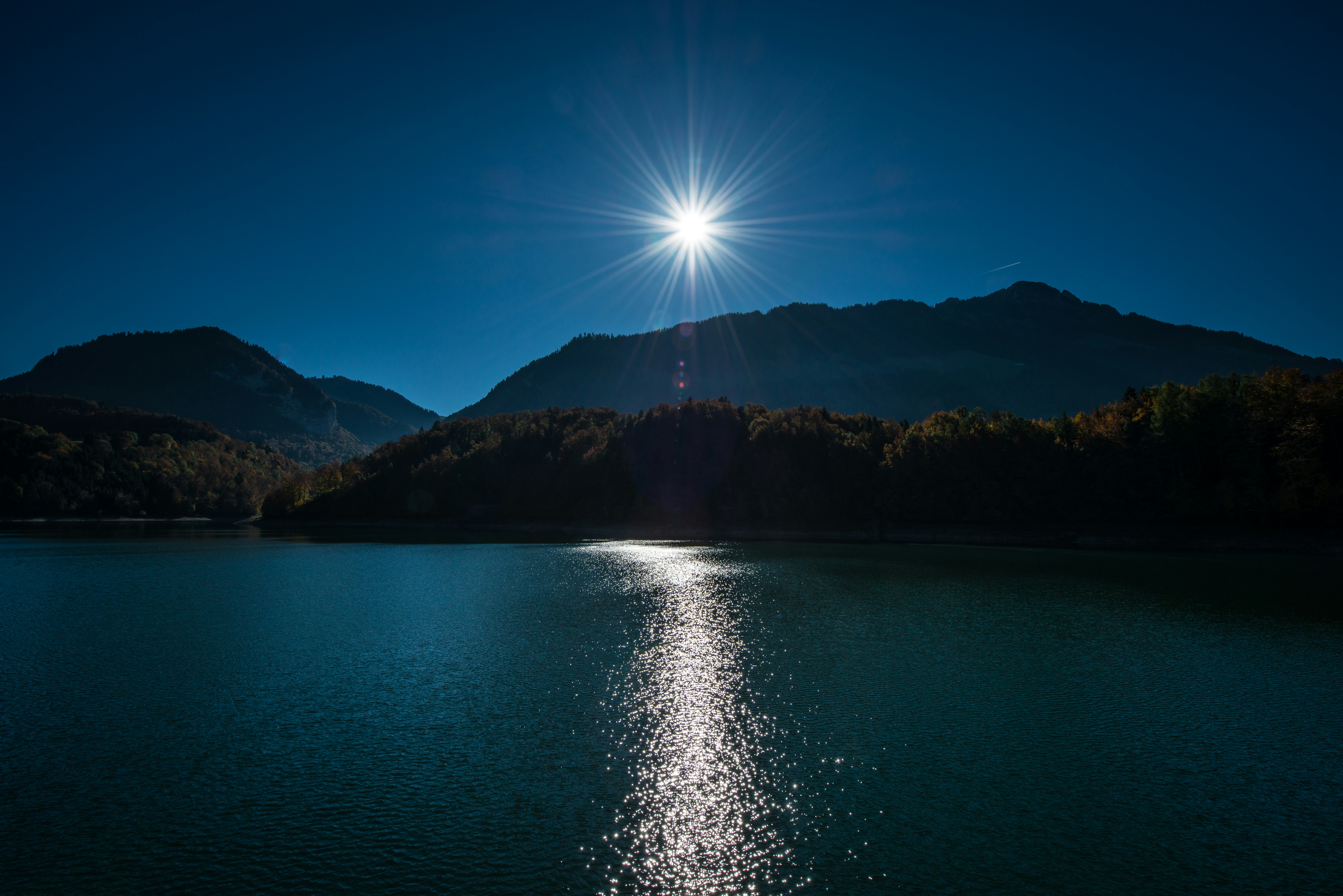 brown mountain near body of water